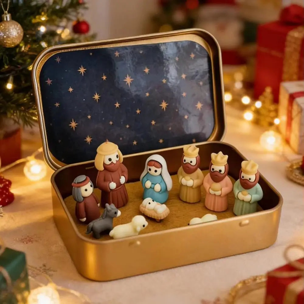 A gold storage tin holds a set of classic PVC Christmas nativity scene figurines with soft lighting.