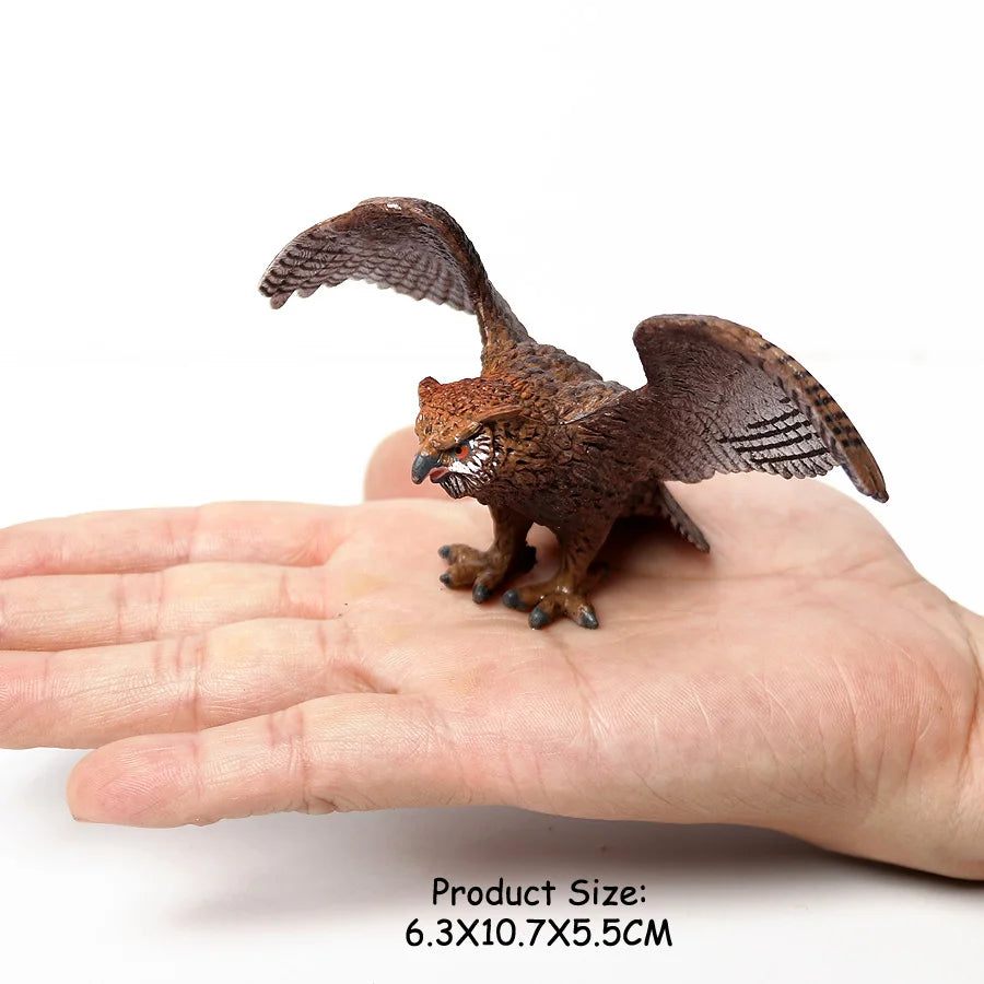 A realistic figurine set of an owl, vulture, and bald eagle perched on a human hand.