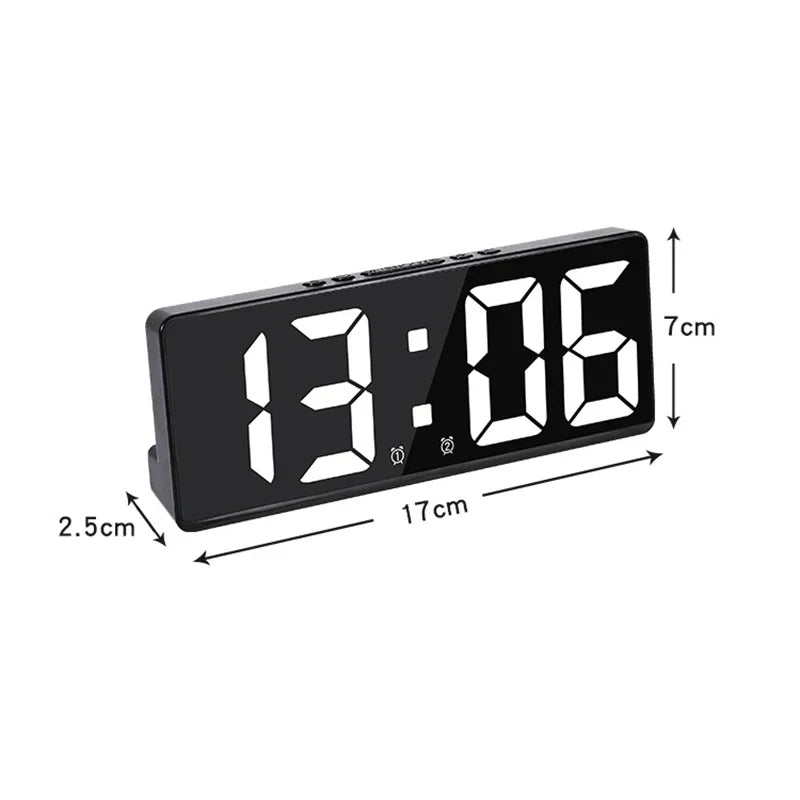 A black LED digital alarm clock displaying 13:06 with dimensions shown.