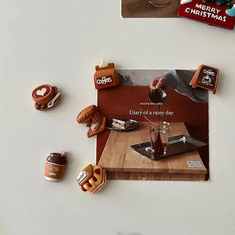 A collection of coffee bean fridge magnets featuring various colors and designs displayed on a wooden surface.