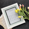 A framed sheet music display featuring the song The Seagulls Praise, surrounded by fresh tulips.