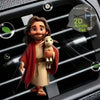 A cute acrylic teddy bear and puppy figure clipped onto a car vent grille.