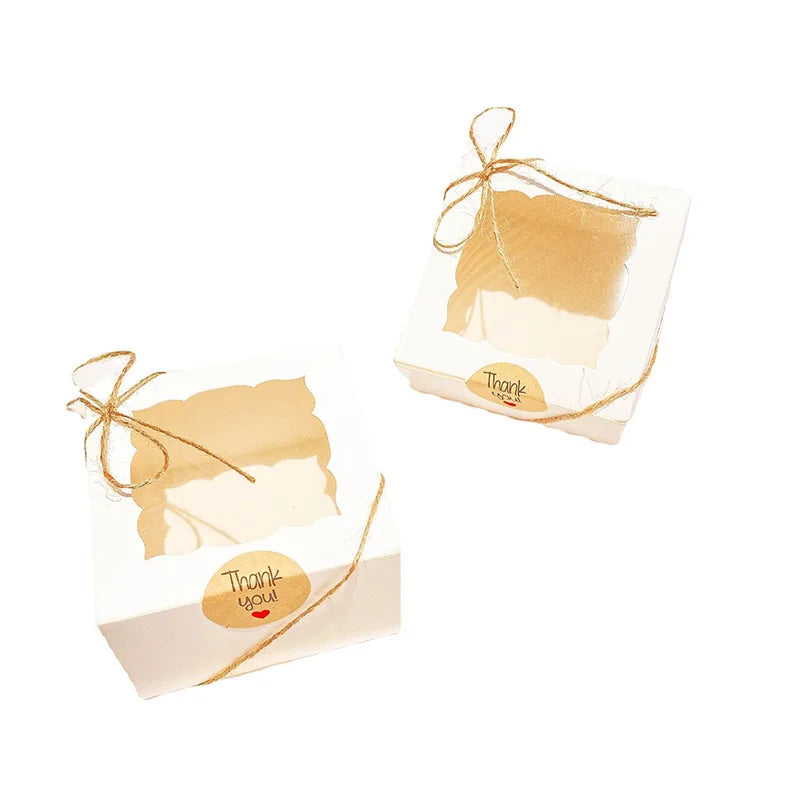 Two small kraft paper favor boxes tied with twine and a thank you tag