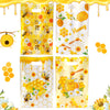 A collection of yellow honeycomb gift bags with handles filled with honey and flowers for party favors