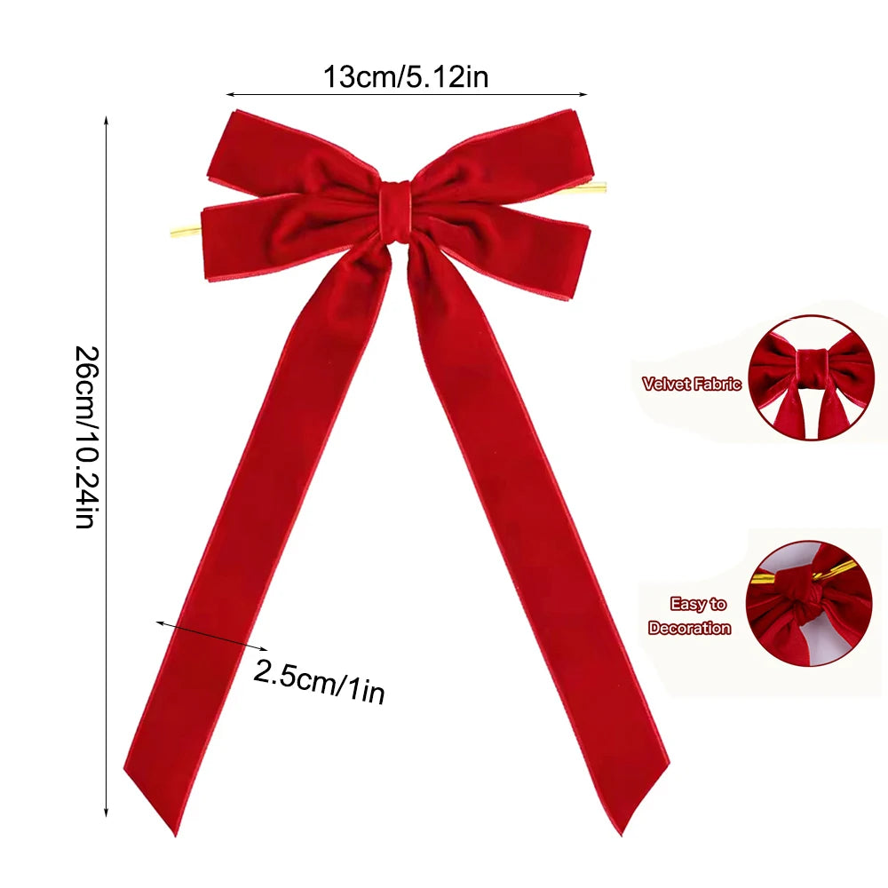 A red velvet ribbon bow with a long tail used for Christmas decorations.