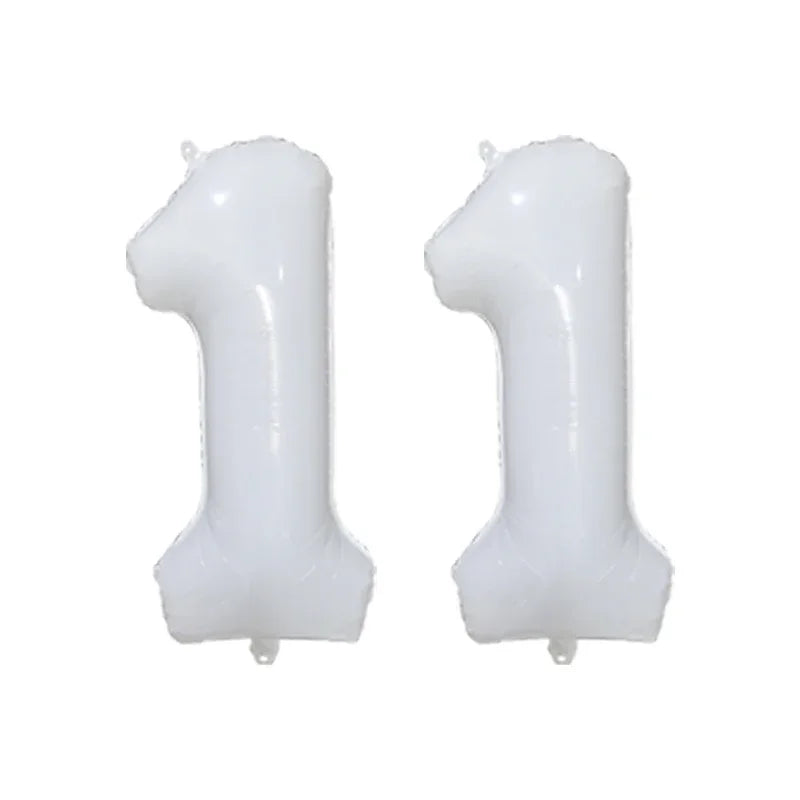 Two white helium foil number balloons shaped like the number 1