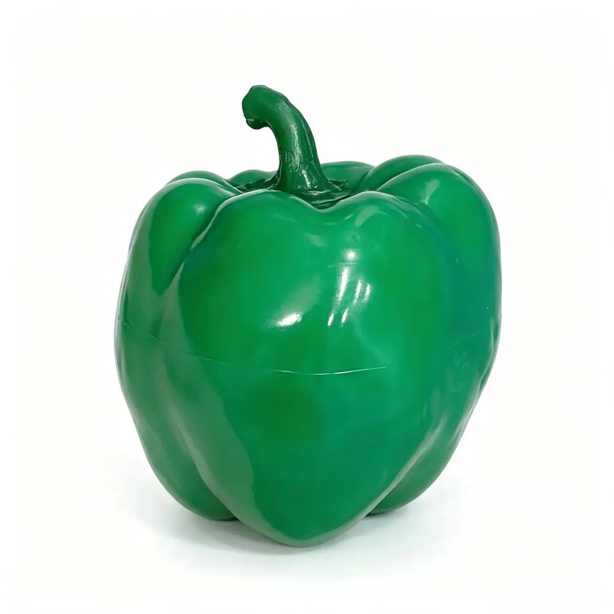 A bright green, glossy bell pepper with a stem, used as a stress relief block.