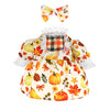 A yellow and orange fall dress for a goose featuring autumn leaf patterns and a matching bow.