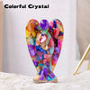 Colorful crystal figurine shaped like a guardian angel with various translucent and colored stones