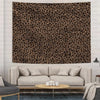 A close-up of a brown and black leopard print wall tapestry hanging on a light-colored wall.