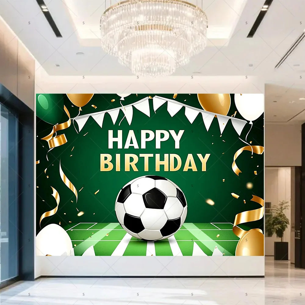 A green backdrop for a birthday celebration featuring a soccer ball, gold balloons, and confetti.