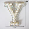 A white pearl and rhinestone alphabet letter V patch with dimensions 4.5cm high and 4cm wide.