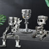 A set of mechanical punk style piston skull sculptures made of silver metal.