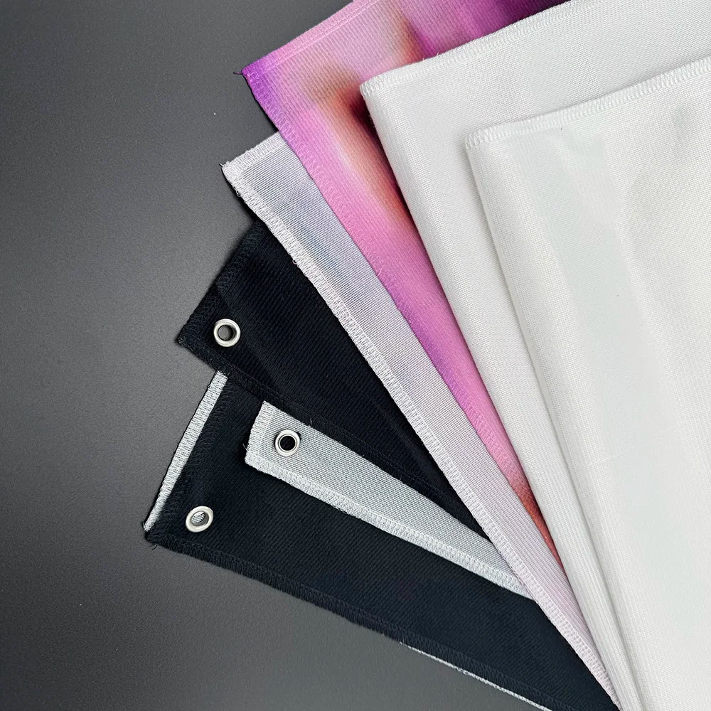 A stack of pink, white, and black tapestry art featuring Banksy-inspired street graffiti designs.