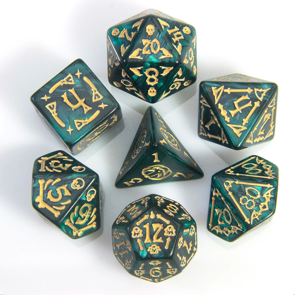 A set of seven polyhedral dice in dark green glass with gold accents arranged on a white surface.