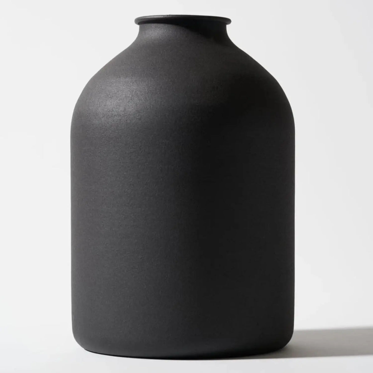 A large matte black decorative vase with a smooth, rounded body.