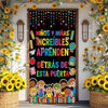 A colorful door banner featuring children learning and a vibrant floral arrangement.