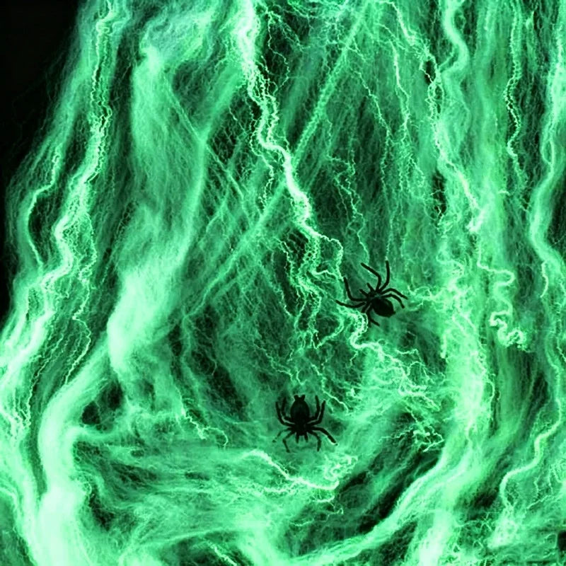 A vibrant green glow-in-the-dark spider web pattern with small black spiders against a dark background.