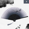 A black and white image of a vintage silk bamboo folding hand fan with delicate floral accents.