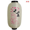 A white paper hanging lantern featuring a pink floral design and Japanese characters on the front.