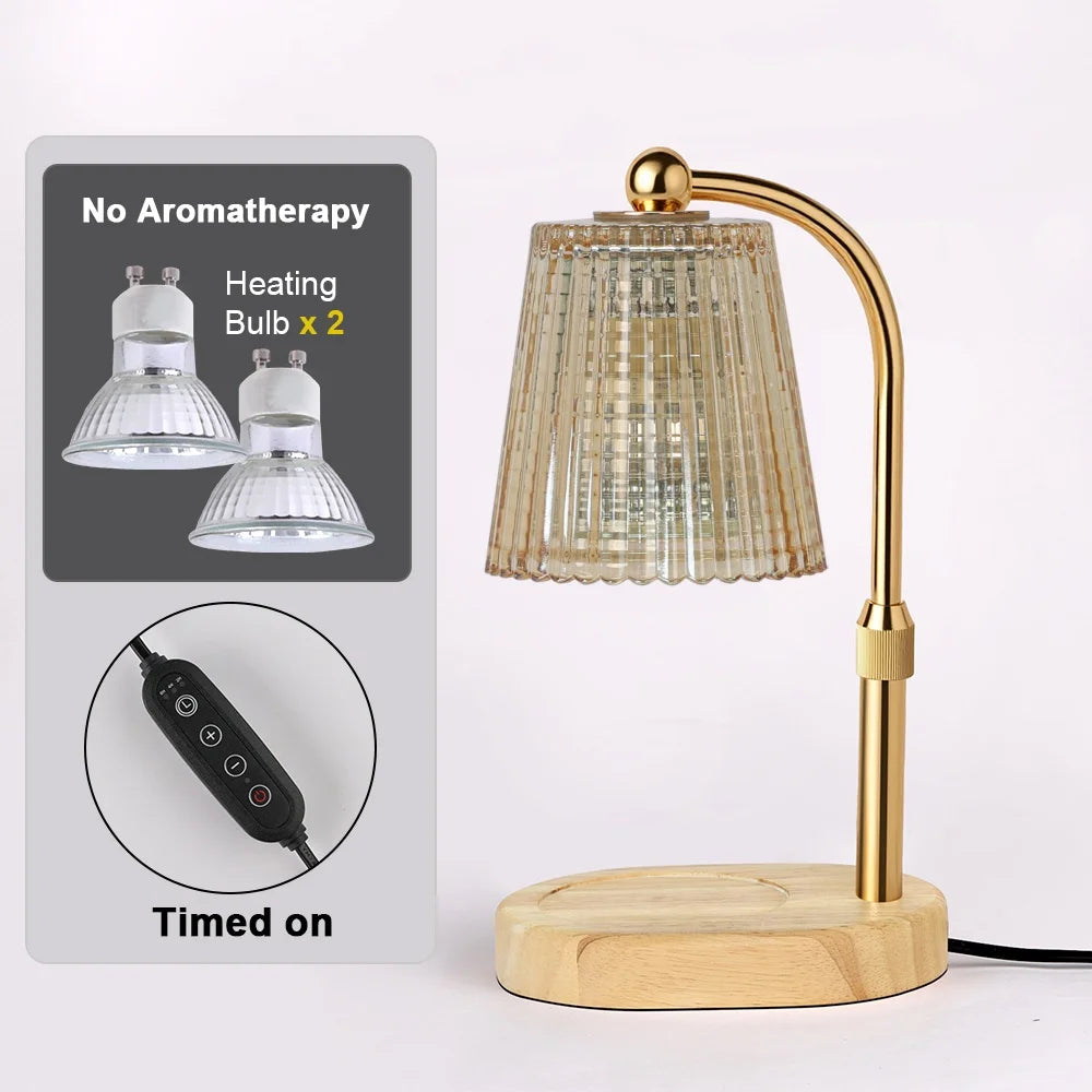 A gold-toned adjustable electric candle warmer lamp with a glass shade and wooden base, next to components for heating bulbs.