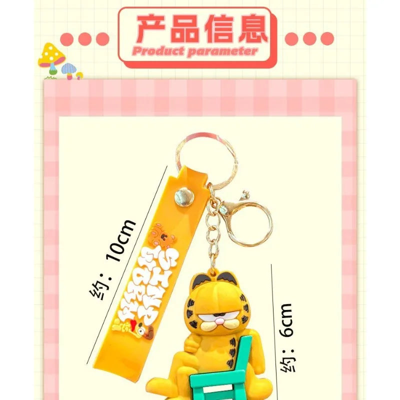 A yellow Garfield cartoon character keychain pendant with a green box attached.