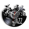 A silhouette of a jazz musician playing a trumpet and saxophone on a vinyl record-shaped wall clock.