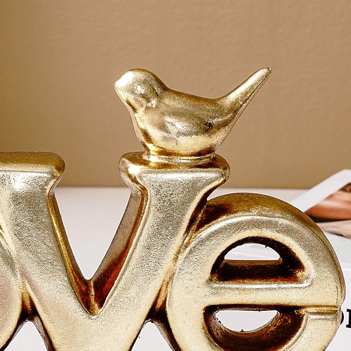 Retro gold and silver foil resin letters spelling the word LOVE