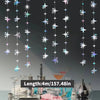 A display of glittering star and polka dot garland lights hanging vertically above a table setting.