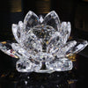 A clear crystal lotus flower ornament with multiple petals displayed on a reflective surface.