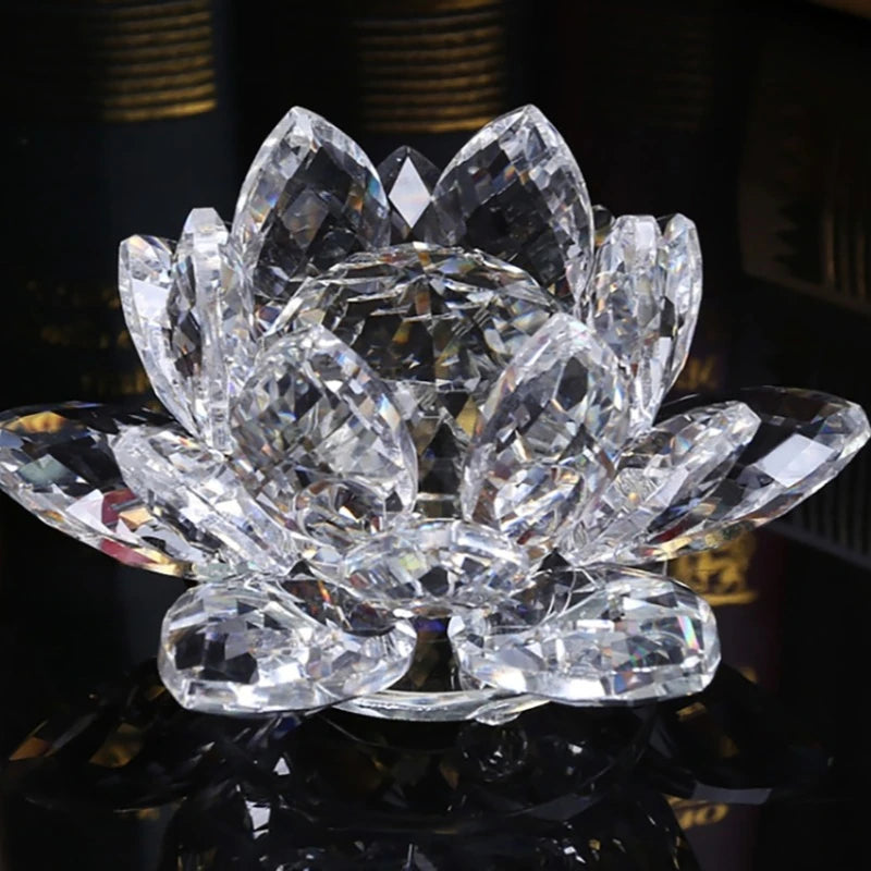 A clear crystal lotus flower ornament with multiple petals displayed on a reflective surface.