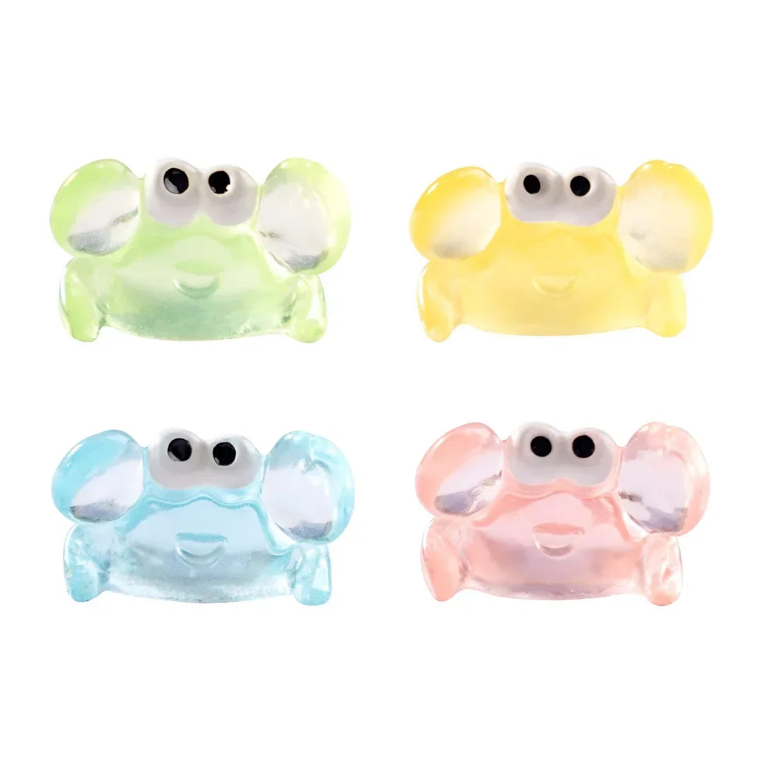 A set of four luminous resin mini crab decor figures in green, yellow, blue, and pink.