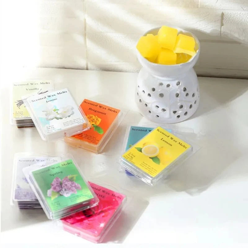 A collection of scented wax melts in various colors and scents, including lemon and vanilla, displayed next to a yellow wax m