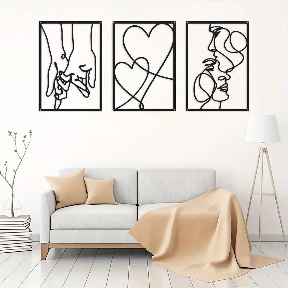 A set of three black line art prints depicting holding hands, a heart, and a profile of a face.