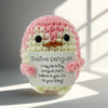 Handmade crochet penguin toy with a positivity card