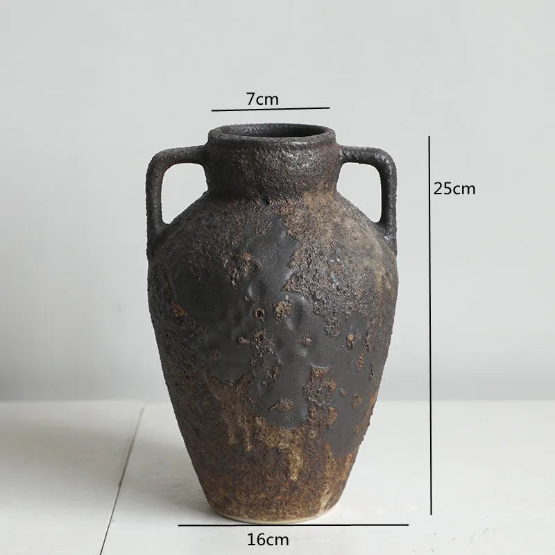 A dark brown vintage dual-sided ceramic vase with handles, shown against a white background.
