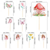 A set of fairy cupcake toppers featuring various floral and butterfly designs on wooden sticks.