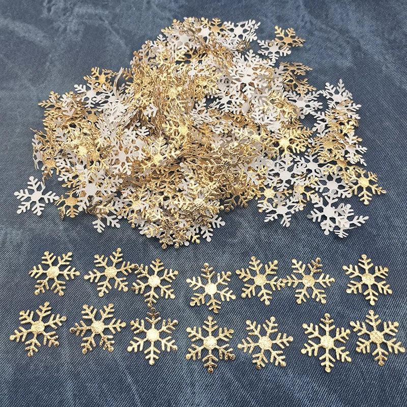 A pile of gold and silver frosted snowflake confetti for holiday decorations