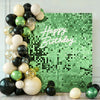 A green grid wall backdrop decorated with balloons and the text Happy Birthday