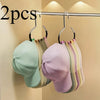A set of two metal hat storage hooks displaying various pastel colored hats.