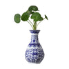 Blue and white ceramic flower vase with green leaves