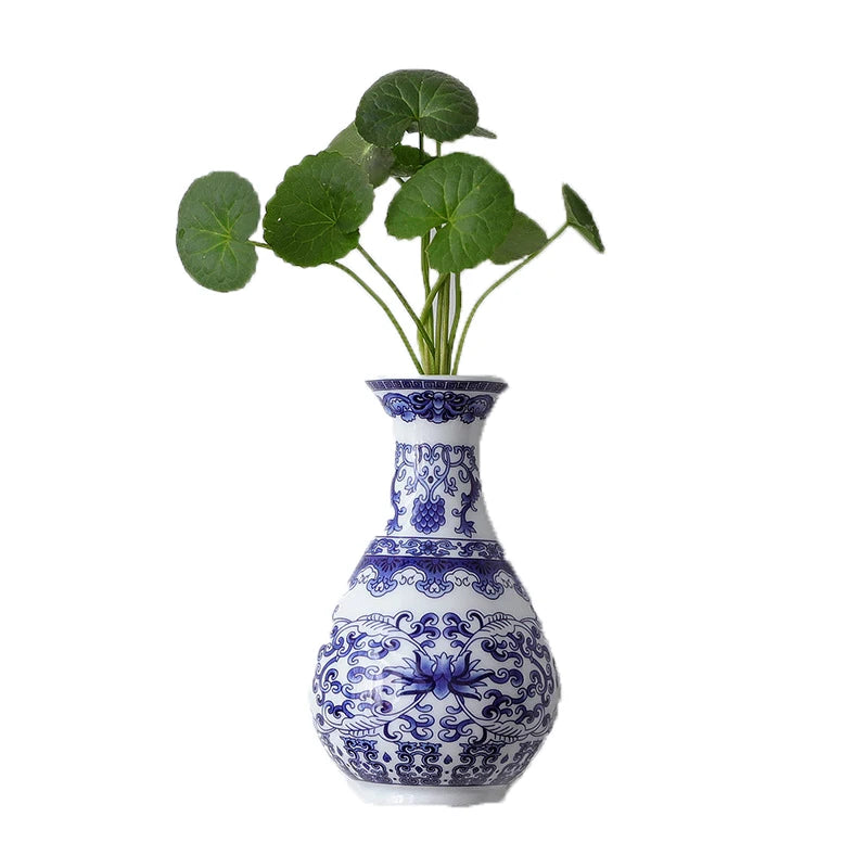 Blue and white ceramic flower vase with green leaves