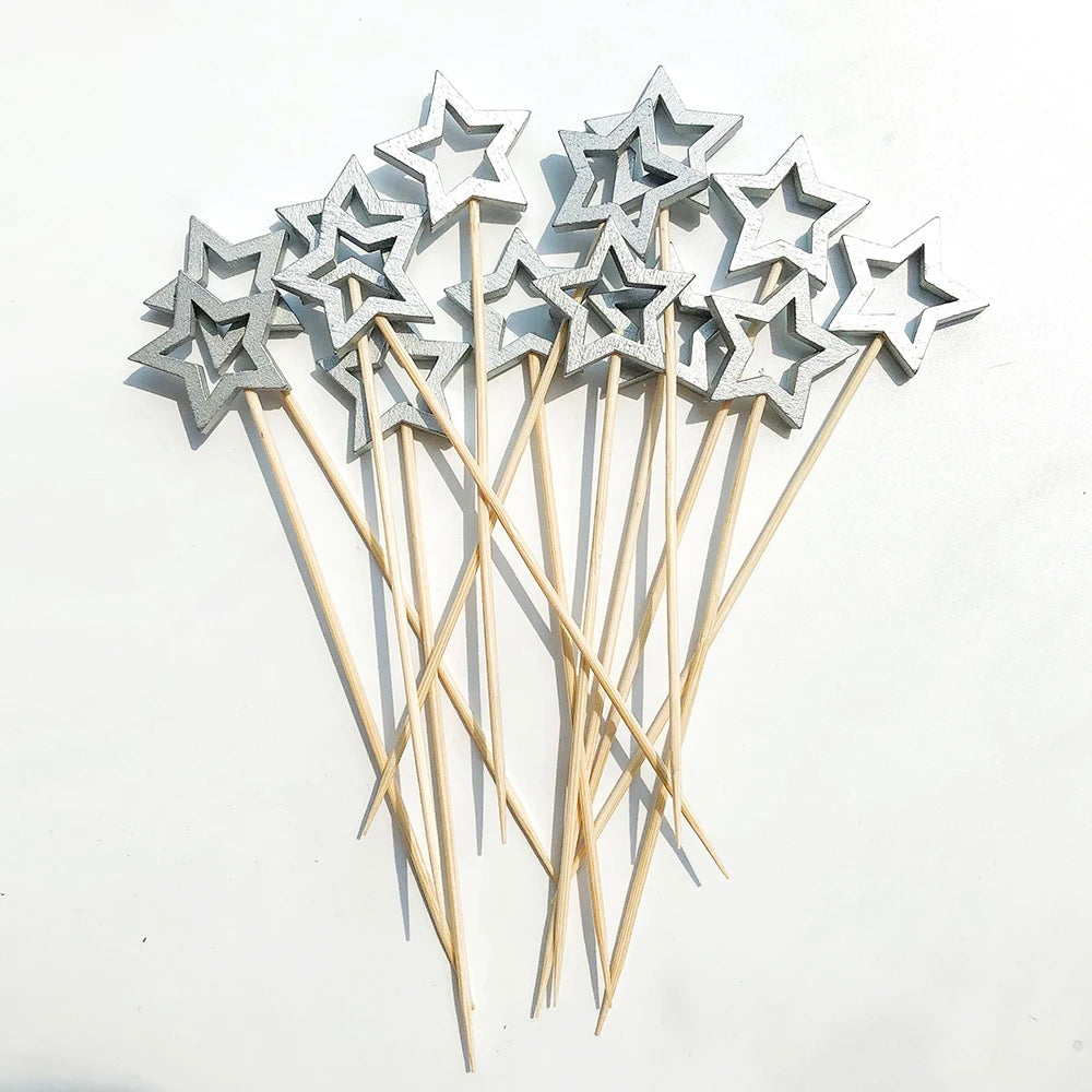 A cluster of silver star-shaped cocktail picks with pearl tips on bamboo sticks.