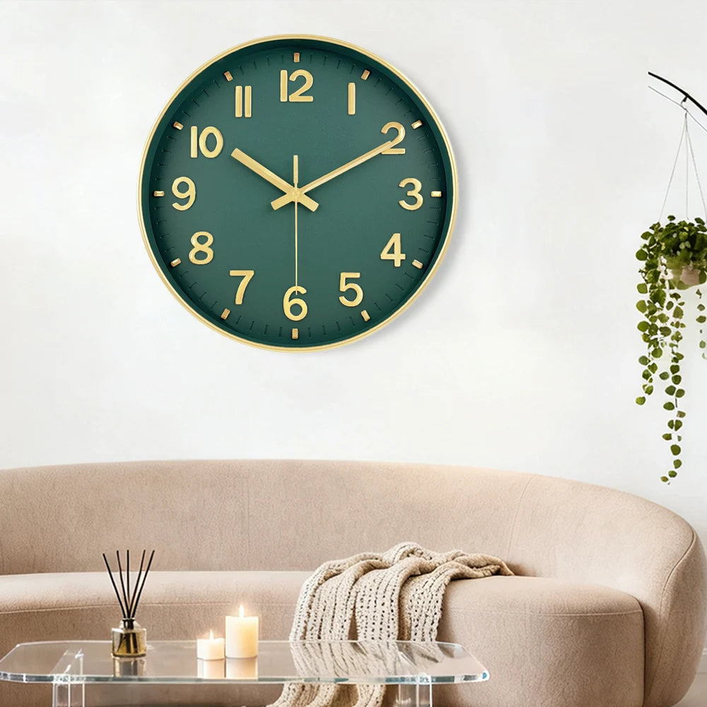 A modern silent quartz wall clock with a green face and gold accents hangs on a white wall above a beige sofa.