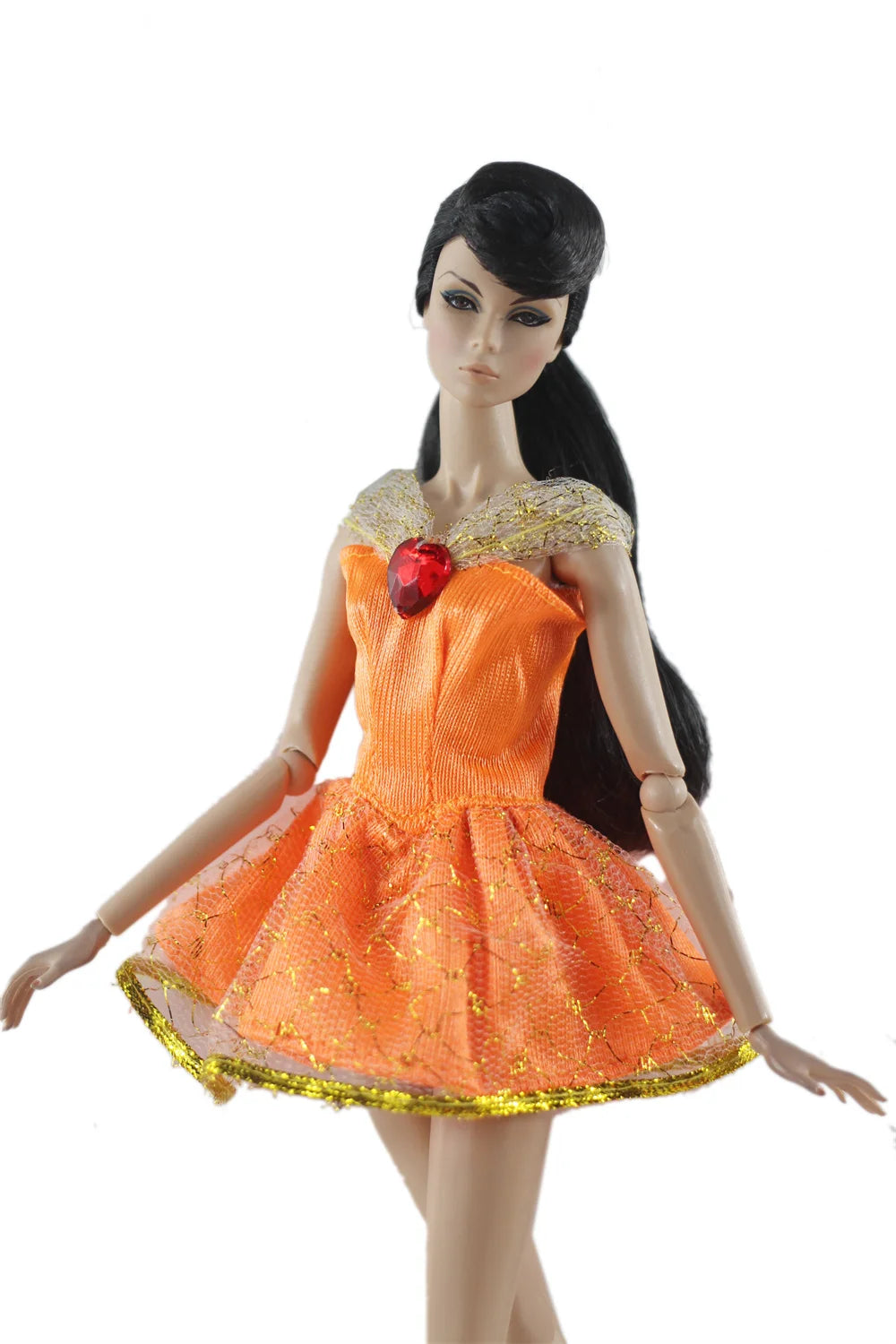 A handmade doll dress gown in bright orange with gold glitter detailing and a red jewel embellishment.