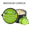 A dark candle jar labeled Massage Candle with Lime Basil Citrus scent and fresh lime slices.