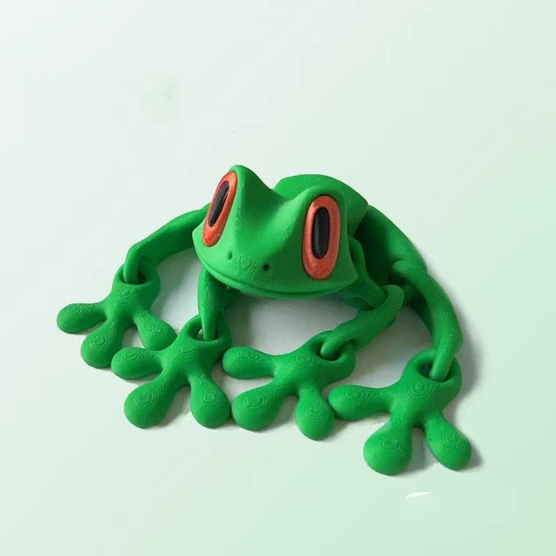 A bright green, movable 3D printed tree frog ornament with orange eyes.