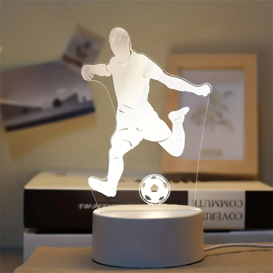 A white 3D LED football night light figure is illuminated on a round base.