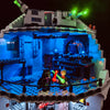 A LEGO Death Star model illuminated with blue LED lighting.