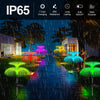 A row of colorful jellyfish garden lights illuminates a pathway under a rainy night sky.